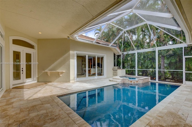 view of swimming pool featuring glass enclosure, an in ground hot tub, french doors, and a patio