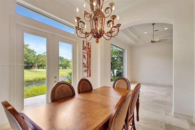 dining area with crown molding, french doors, a tray ceiling, and ceiling fan