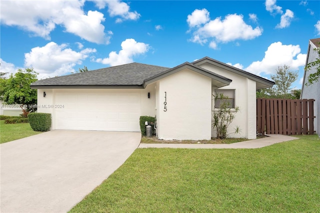 ranch-style house featuring a garage and a front yard