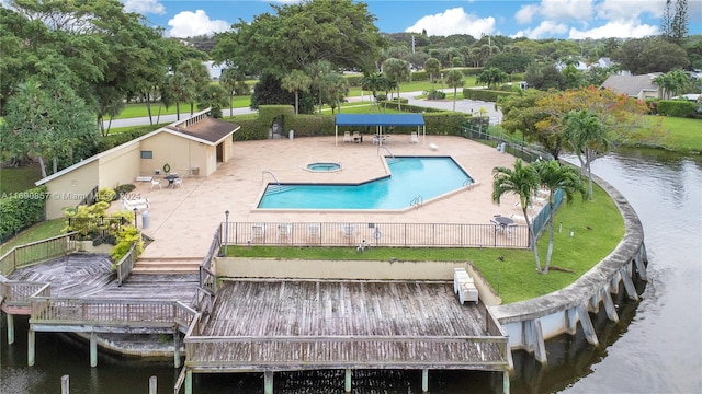 view of swimming pool featuring a patio, a deck with water view, and a yard