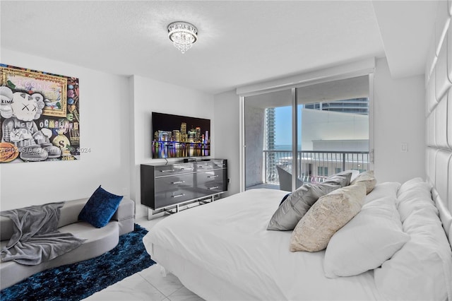 bedroom featuring a textured ceiling and access to exterior