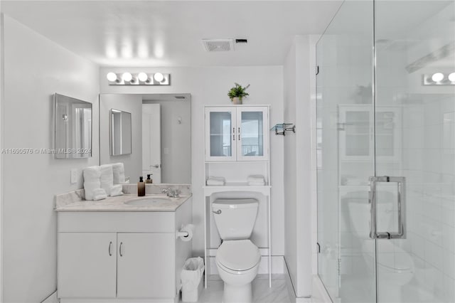 bathroom with vanity, toilet, and an enclosed shower