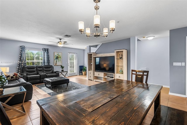 living room with ceiling fan with notable chandelier and tile patterned floors