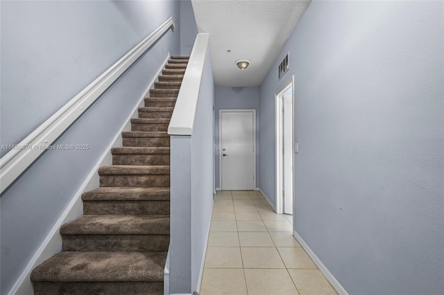 stairway with tile patterned flooring