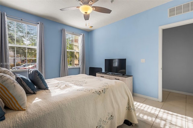 bedroom with ceiling fan and light tile patterned floors