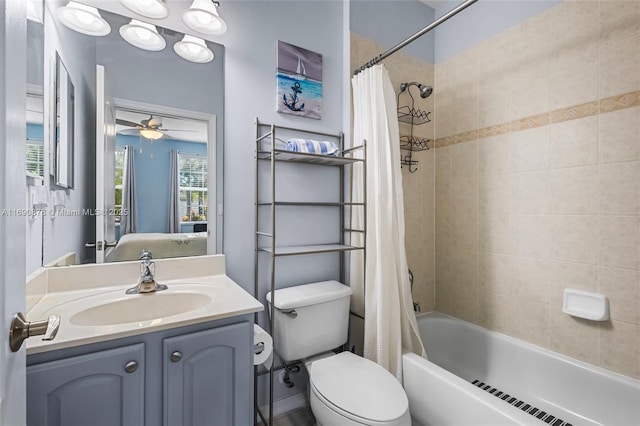 full bathroom featuring toilet, vanity, ceiling fan, and shower / bathtub combination with curtain