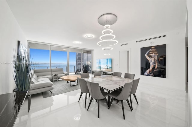 dining area featuring expansive windows and an inviting chandelier