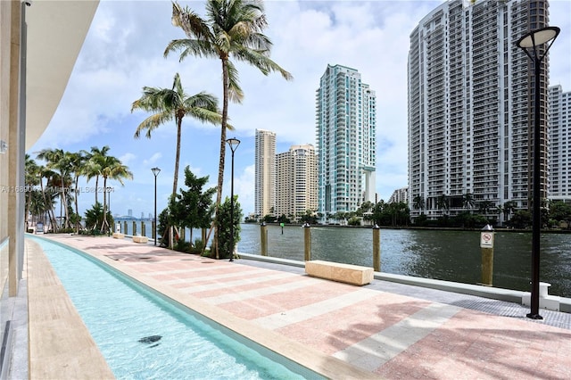 view of swimming pool with a water view