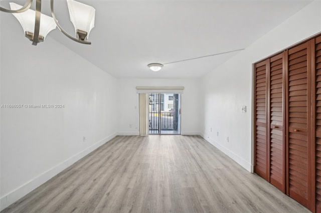 empty room with light hardwood / wood-style flooring