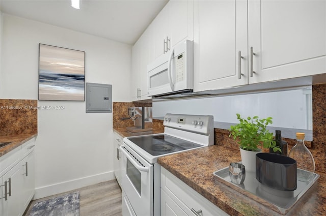 kitchen featuring white cabinetry, light wood-type flooring, and white appliances