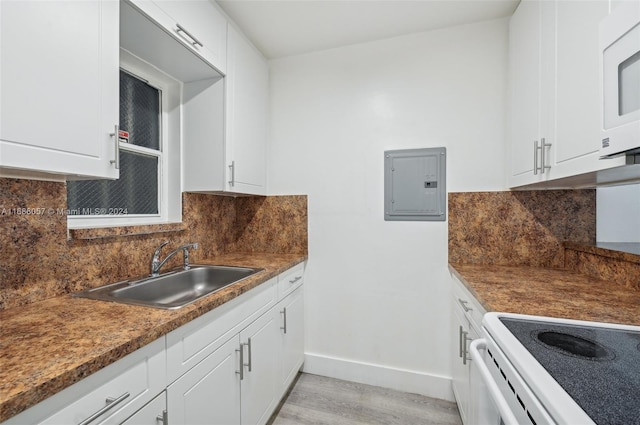 kitchen featuring white cabinetry, electric panel, and sink