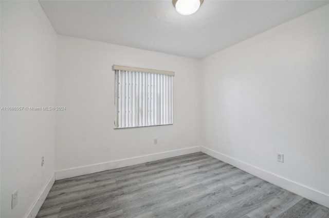 spare room with wood-type flooring