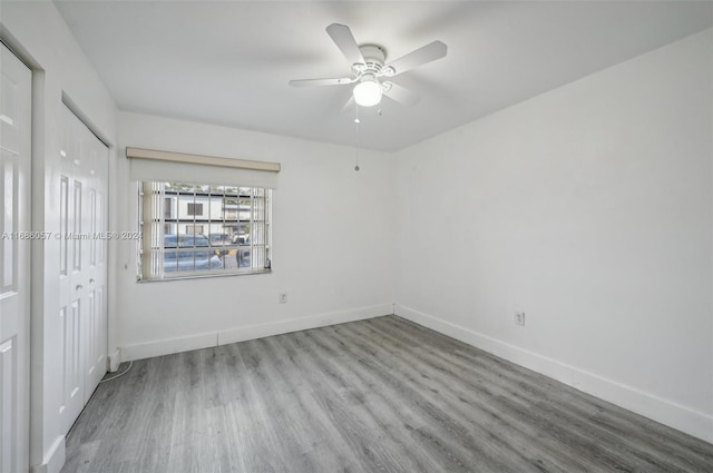 unfurnished bedroom with light hardwood / wood-style floors, ceiling fan, and a closet