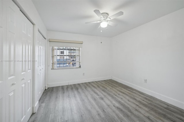 unfurnished bedroom with hardwood / wood-style floors and ceiling fan