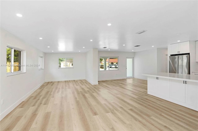 unfurnished living room featuring light wood-type flooring