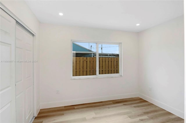 empty room with light hardwood / wood-style flooring