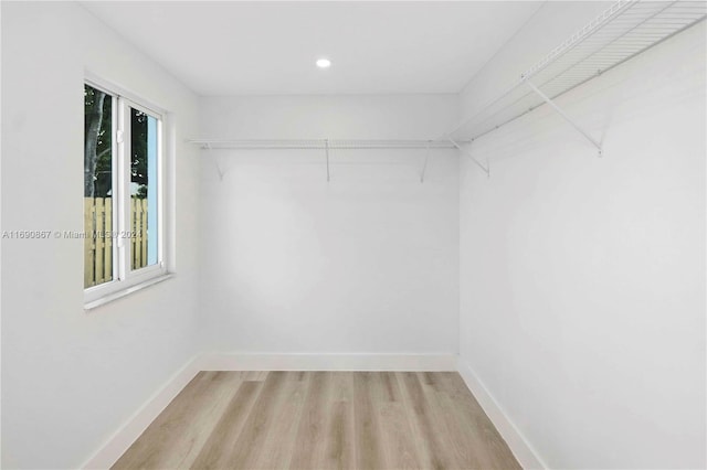 walk in closet with light wood-type flooring