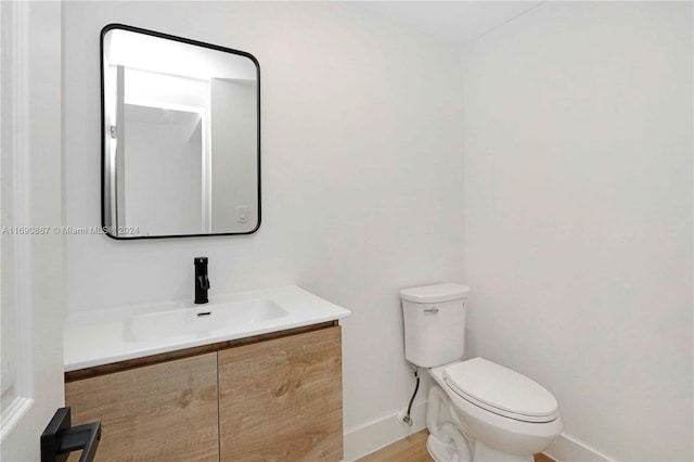 bathroom with toilet and vanity