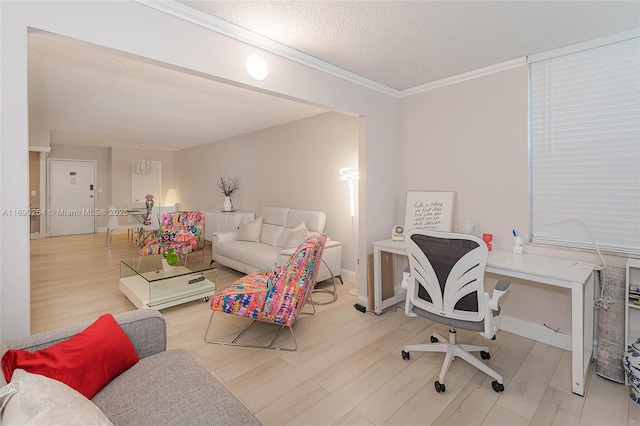 office area with ornamental molding, wood finished floors, baseboards, and a textured ceiling