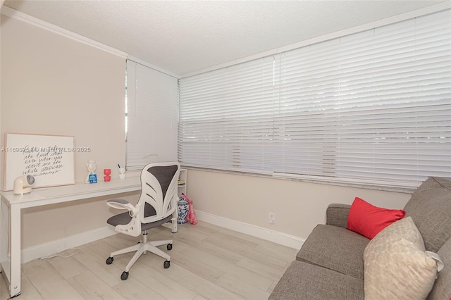 office space featuring baseboards, a textured ceiling, and wood finished floors