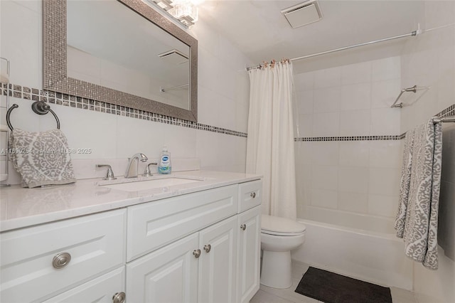 full bathroom featuring visible vents, toilet, shower / bath combo, tile walls, and vanity