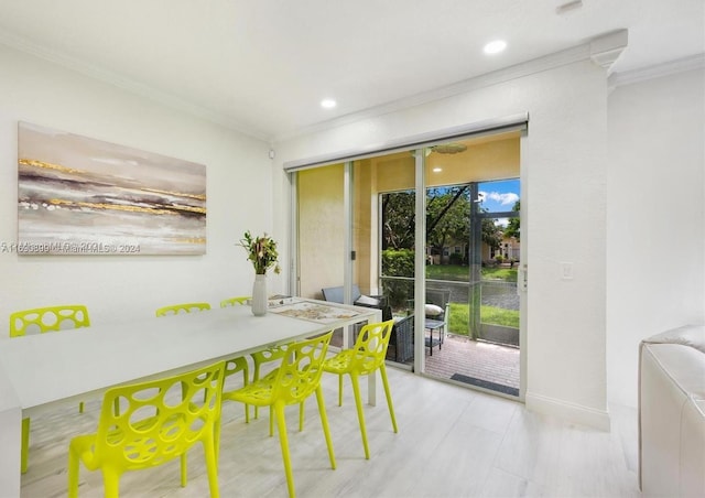 dining area with a wealth of natural light and ornamental molding