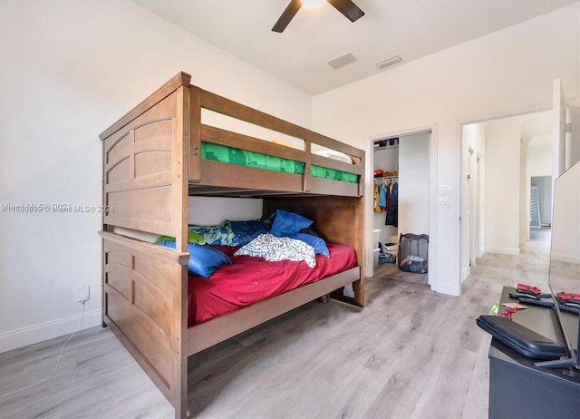 bedroom with ceiling fan, a closet, and wood-type flooring