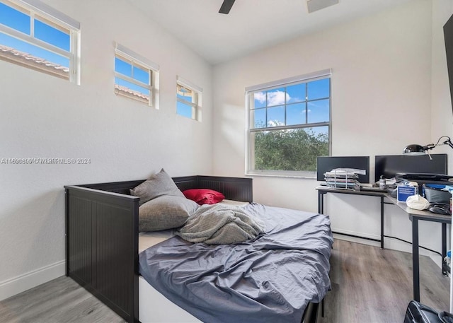 bedroom featuring hardwood / wood-style floors and ceiling fan