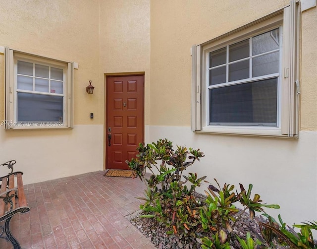 entrance to property featuring a patio