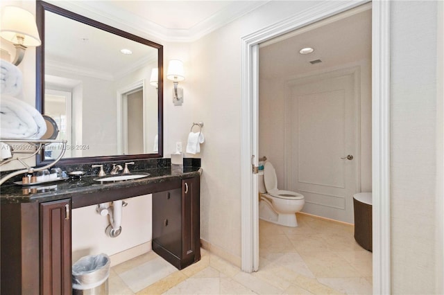 bathroom with toilet, ornamental molding, and sink