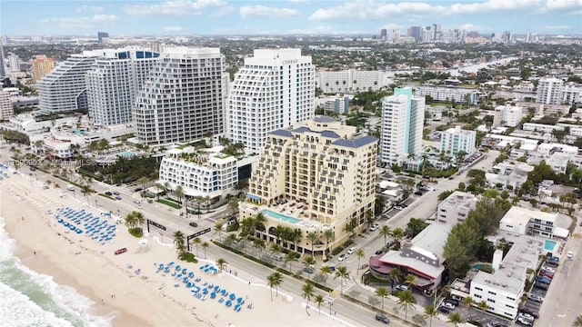 bird's eye view featuring a water view and a beach view