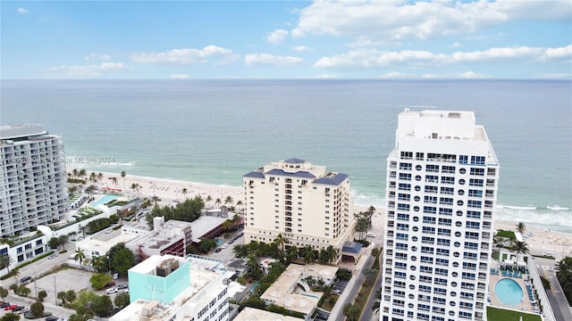 bird's eye view with a water view and a beach view