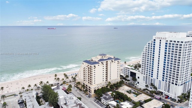 bird's eye view with a water view and a beach view