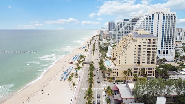 bird's eye view featuring a water view and a beach view