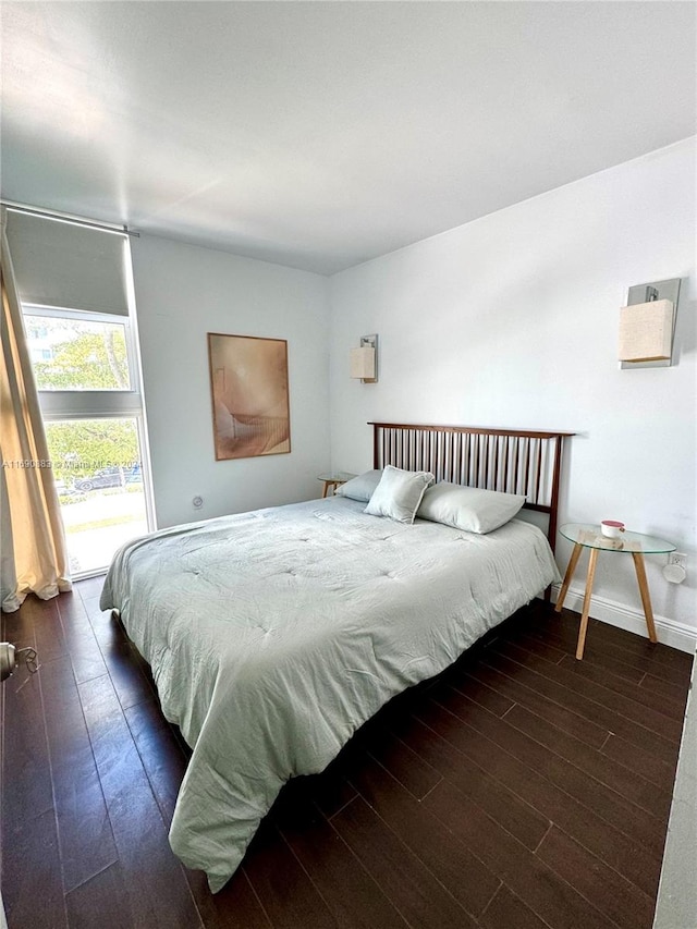 bedroom with dark hardwood / wood-style floors