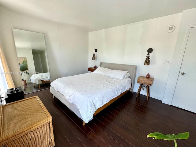 bedroom with dark wood-type flooring