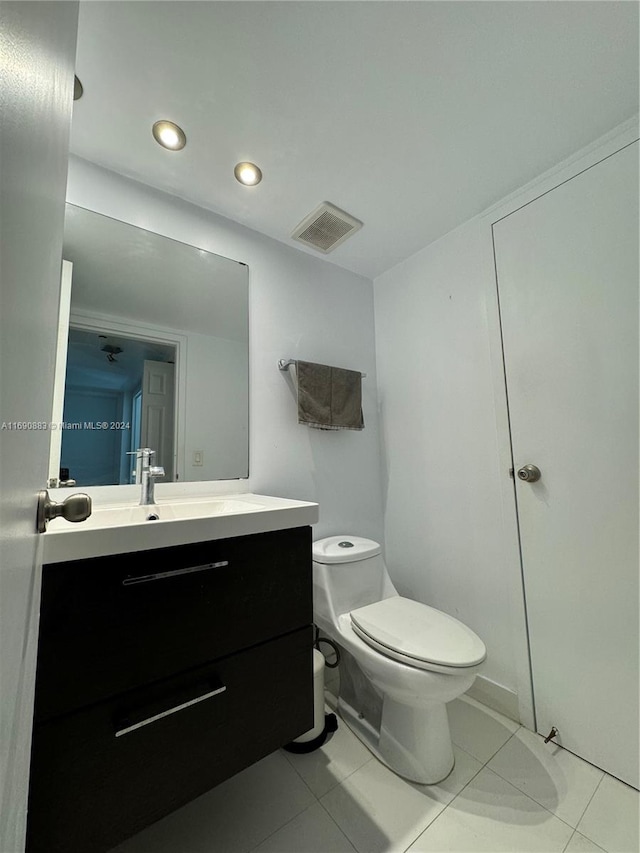 bathroom featuring toilet, vanity, and tile patterned flooring