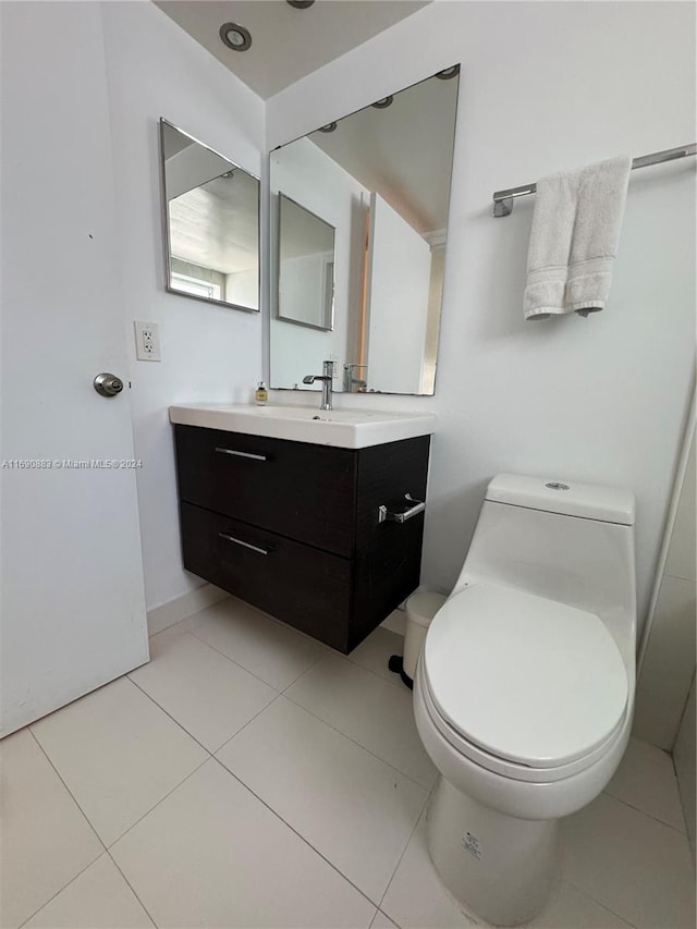 bathroom with vanity, tile patterned floors, and toilet