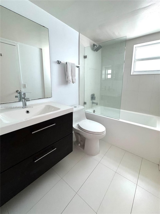 full bathroom with toilet, vanity, tiled shower / bath, and tile patterned flooring