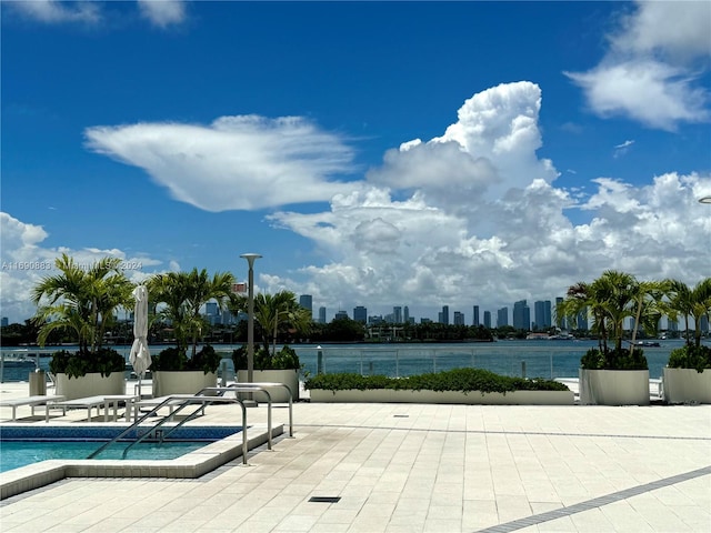 exterior space with a water view and a patio area