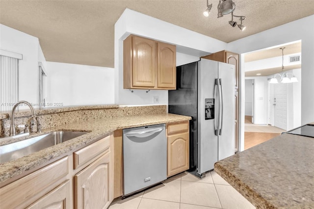 kitchen with light countertops, visible vents, appliances with stainless steel finishes, light brown cabinets, and a sink