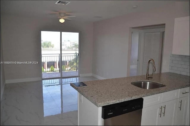 kitchen with light stone counters, white cabinets, sink, stainless steel dishwasher, and ceiling fan