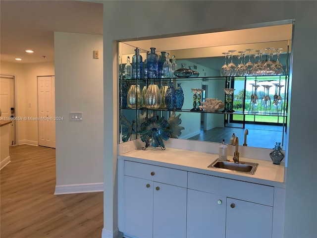 bar with sink and hardwood / wood-style flooring