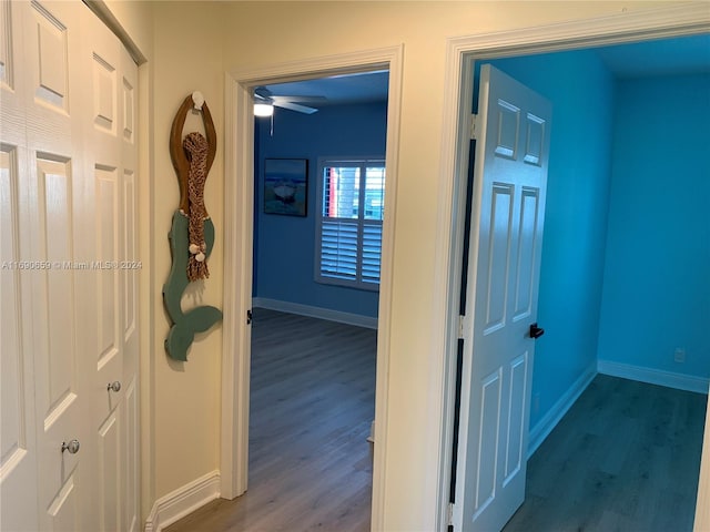 hallway with hardwood / wood-style flooring