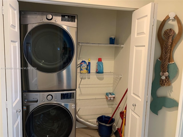 clothes washing area featuring stacked washer / drying machine