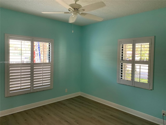 empty room featuring a textured ceiling, hardwood / wood-style flooring, and ceiling fan