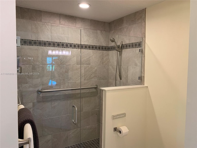 bathroom featuring a shower with door