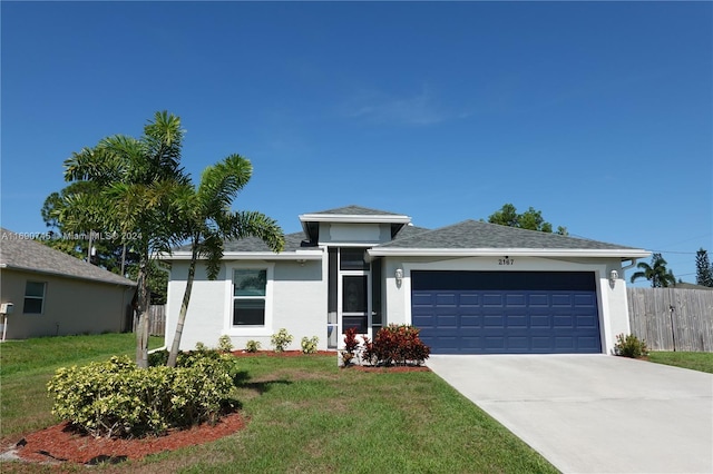 view of front of house with a front yard and a garage