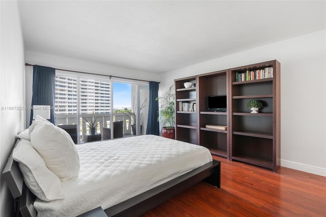 bedroom with dark wood-type flooring