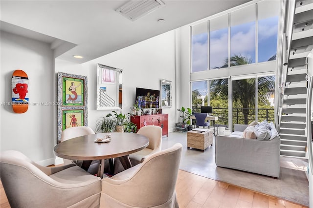 kitchen featuring stainless steel appliances, a raised ceiling, light hardwood / wood-style floors, and sink